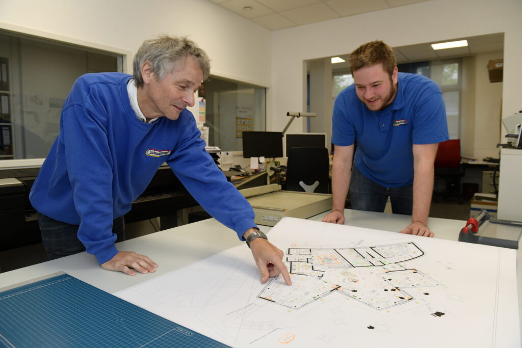 CAD Planung Elektroinstallation Troisdorf – Elektro Schwarzkopf Team bespricht Installationspläne am Planungstisch